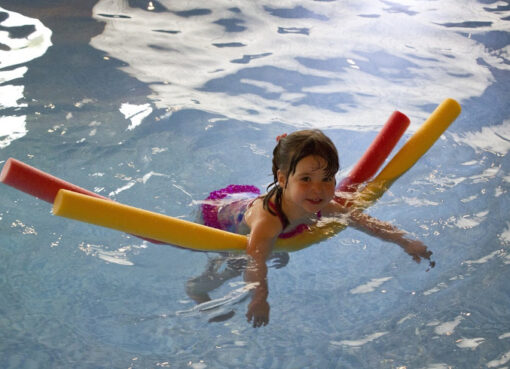 Mit der Nudel starten die ersten Schwimmübungen.